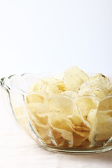 Delicious potato chips in bowl