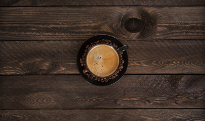 Coffee on the wooden table. Coffee beans with a wooden texture. View from the top