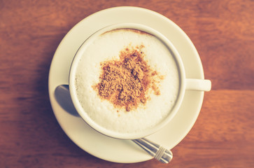 Hot latte art coffee on table ( Filtered image processed vintage