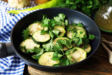 Sliced zucchini in pan on table, closeup