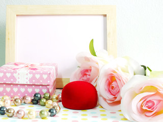 blank photo wood frame with pink roses and gift box on sweet flower