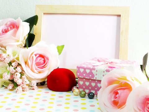 blank photo wood frame with pink roses and gift box on sweet flower