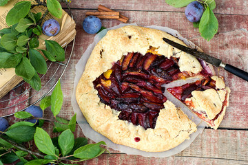 Rustic galette fruit tart with plums and cinnamon