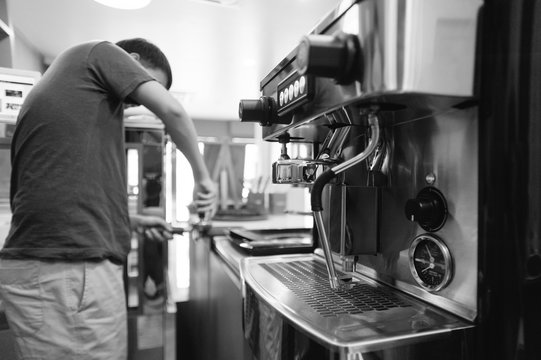 Coffee Machine with barista in the background