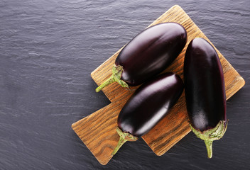 Fresh eggplant on wooden table, top view