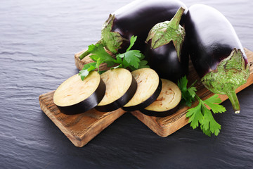 Fresh eggplant on cutting board on wooden table, closeup © Africa Studio
