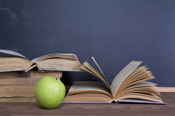 books and apple slate background