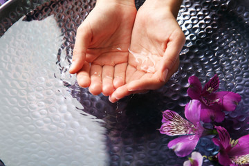 Female hands at spa manicure procedure