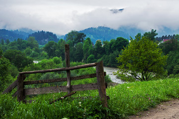 Fototapeta na wymiar Rural landscape with mountains and fog