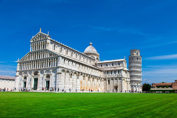 PISA, ITALY - MAY 10, 2014: Tourists on Square of Miracles visiting Leaning Tower in Pisa, Italy....