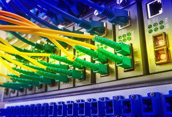 Fiber Optic cables connected to an optic ports and Network cable
