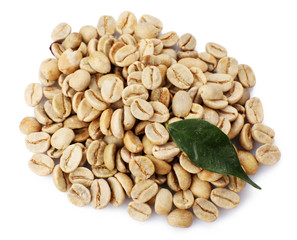 Heap of green coffee beans with leaf isolated on white