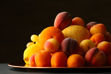 Heap of fresh fruits on dark background