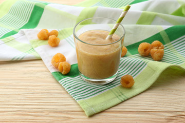 Raspberry smoothie with berries on table close up