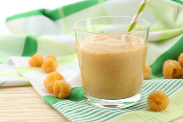Raspberry smoothie with berries on table close up