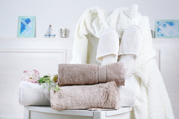 Bath set with white bathrobe on chair, indoors - obrazy, fototapety, plakaty