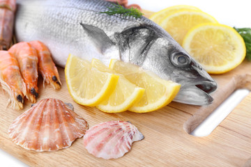 Fresh zander fish on wooden cutting board, closeup