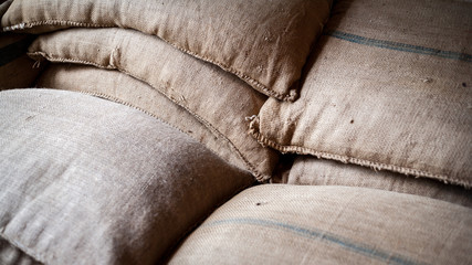 Hessian Sacks. Full frame detail from within a warehouse packaging their goods in woven canvas...