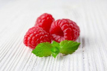 Fresh red raspberries on wooden background