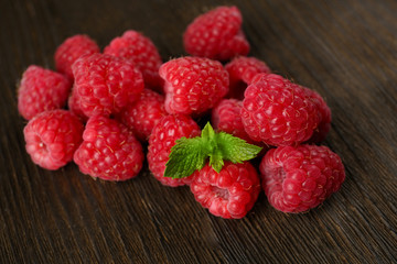Fresh red raspberries on wooden background