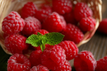 Fresh red raspberries on wooden table, closeup