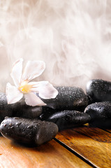 Group of stones on wood with steam background vertical compositi