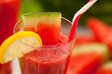 Close up of watermelon juice with lemon and straw