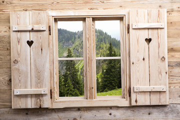 Wooden window with mountain reflections