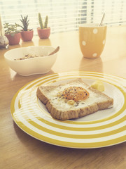 Breakfast . Fried egg on the toast , Muesli yogurt and coffee