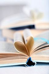 Pages of book curved into heart shape, close up