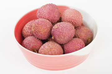 Lychees - Fresh lychees in a pink bowl.
