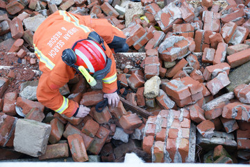 fire-fighters at building collapse disastor