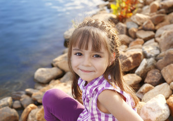 smiling girl by the pond