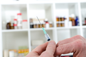 Doctor preparing a syringe