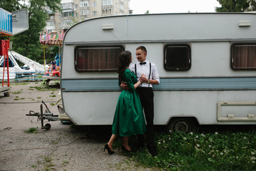 man and woman is hidden from view behind a trailer