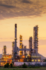 Obraz na płótnie Canvas Big Industrial oil tanks in a refinery with treatment pond at industrial plants