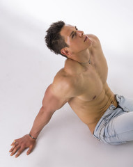 Fototapeta na wymiar Handsome young bodybuilder laying down on the floor