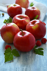 Fresh red apples with raspberries