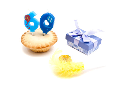 cupcake with sixty years birthday candle, gift and whistle