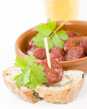 Chorizo a la Sidra - Spanish spicy chorizo sausages cooked in cider on top of crusty bread.
