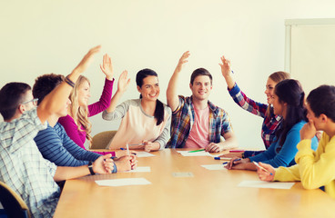 group of smiling students voting
