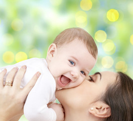 happy mother with baby over green background