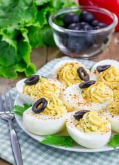 Spicy deviled eggs garnished with olives