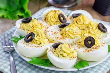Spicy deviled eggs garnished with olives