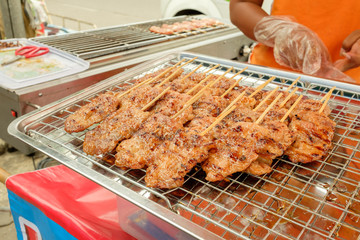 Street food traditional thai style grilled pork.