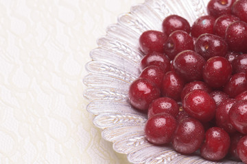 Sour cherry on a silver plate