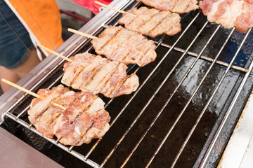 Street food traditional thai style grilled pork.