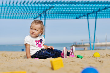 baby girl playing in sand