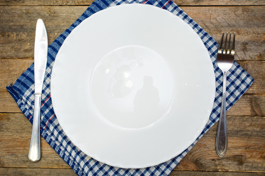 cutlery and a white plate