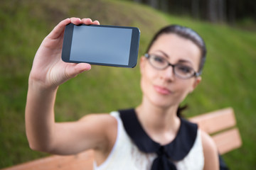 beautiful woman showing smart phone with blank screen